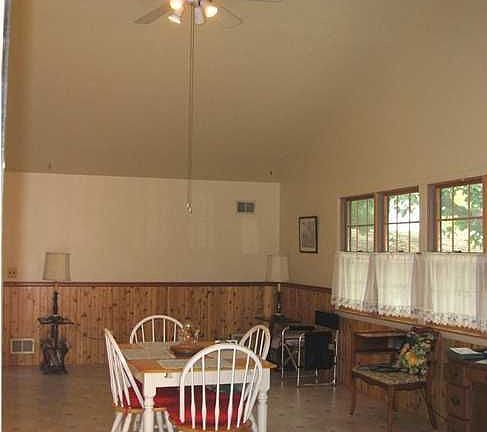 great room/family room with newer windows and wood burning stove