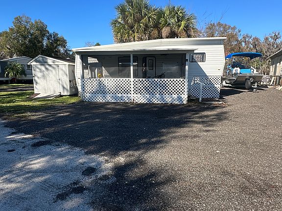 Fifth-Wheel with Screened-In Porch on the Front, Shed on the Left and Private Washer/Dryer (W/D) Building in the back