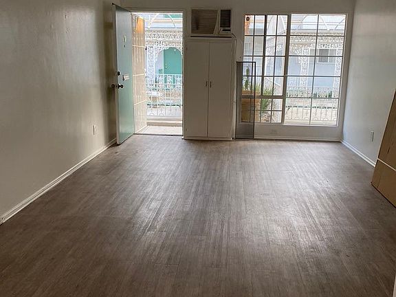 View of apartment 10 entrance and living space, and shared courtyard from kitchen/dining room area.