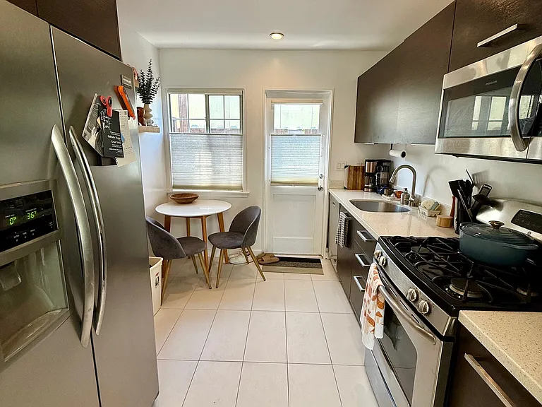 Kitchen with large stainless steel refrigerator