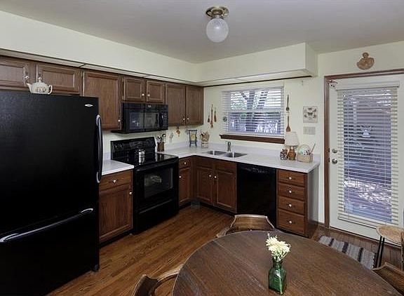 Corian counters, double stainless sinks, newer appliances and door leads you to the back patio.