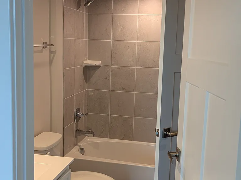 shared attached full bathroom in lower level. two doors to this bathroom, one access from the hallway, one from the room