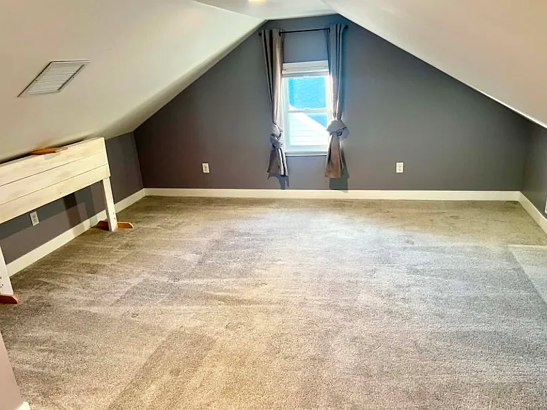 King/Queen mattress can fit under roof or against window. A split king box spring is easy to bring up and down stairs. A queen box spring cannot fit through the doorway, mattress only...unless built in place (can help with building a raised platform).