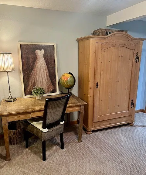 Desk and large armoire (in bedroom).