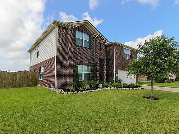 Another view of this 5 bedroom, 2 1/2 bath home with 2 car attached garage.