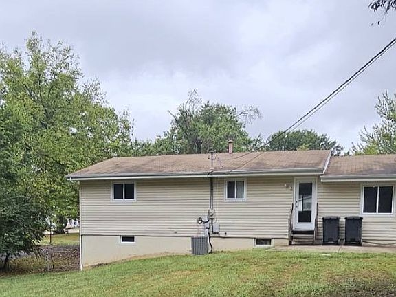 Back of house and patio with rear-entry to kitchen