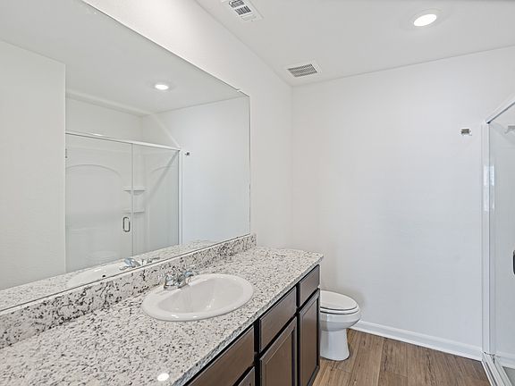 Master bathroom with a walk-in shower and expansive countertops.