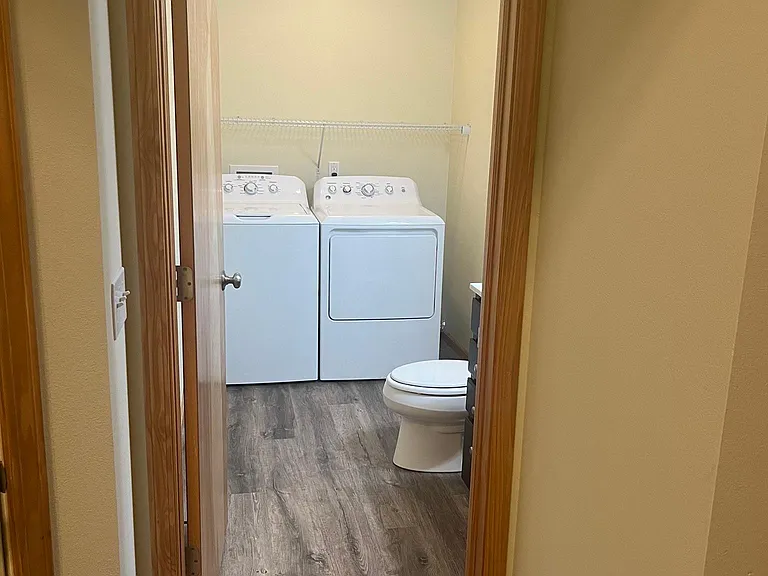 Main floor half bath with washer and dryer.