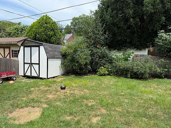Fenced in backyard with storage shed