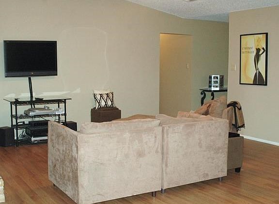 View is from kitchen, looking into den with hallway to bedro