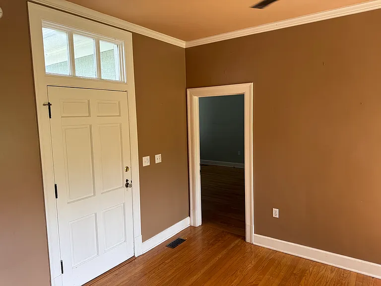 A smaller room that leads into two bedrooms.