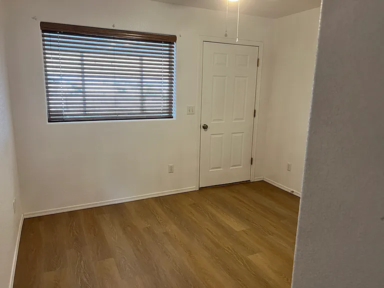 Third bedroom with window and door to Arizona room