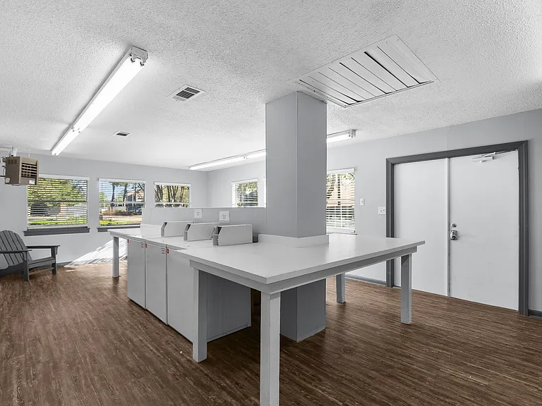Convenient on-site laundry facilities with folding tables for residents at Lakeland East Apartments in Flowood, MS. Managed by Highlands Vista Group.