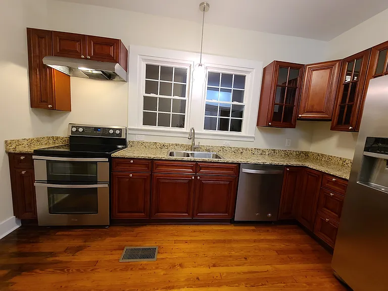 Kitchen w/ new cabinets, granite counters, electric ss stove/oven, ss overhead stove light/vent, ss dishwasher, ss double sink, garbage diposal, and ss french door refrigerator.
