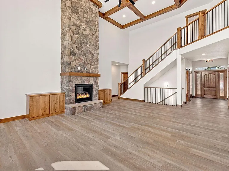 Fireplace to entrance and staircase to loft