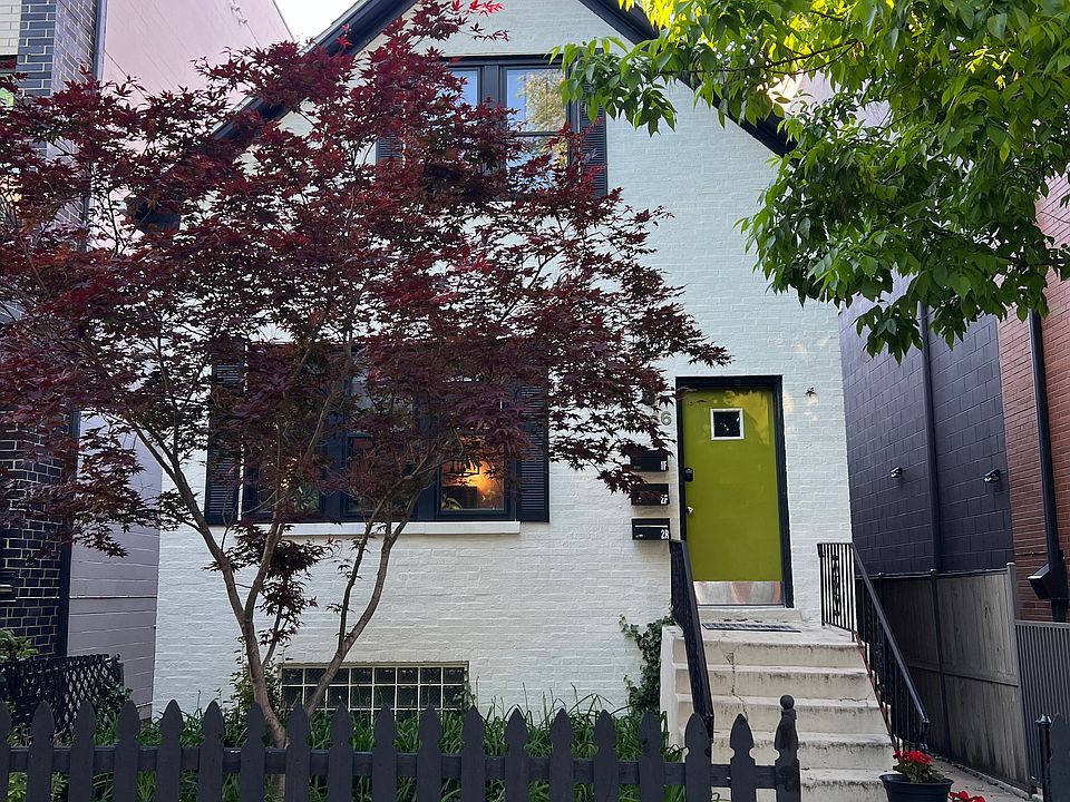 View of the front house on the property - the sidewalk to the right of the house leads to the coach house in the back where the listing is located.