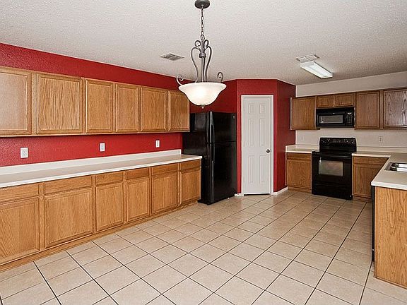 The kitchen offers an abundance of cabinets and counter space, built in microw
