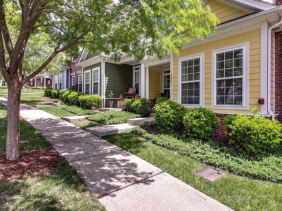 Sidewalk lined street in quiet and manicured neighborhood