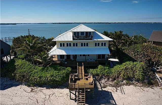 Aerial View. Ocean beachfront in foreground. Intracoastal Waterway on the river side.