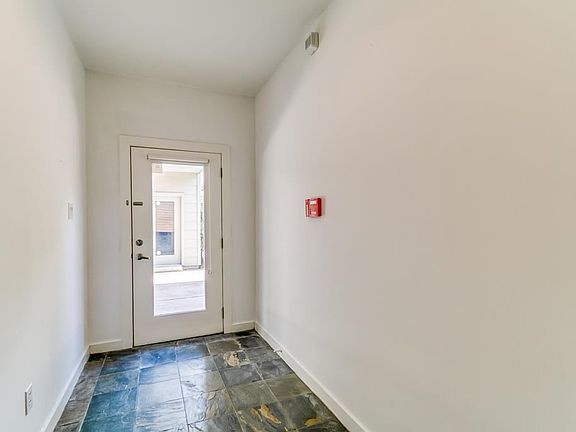 Natural light pours into this slate foyer.