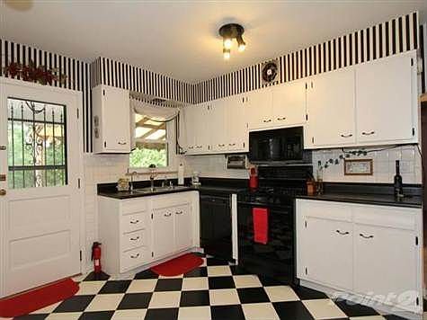 This large kitchen features a gas stove plus an instant hot water tap. Large energy efficient windows bring you plenty of natural light and you can also enjoy the wooded view while you cook!! A walk out to the covered porch makes it easy to have a picnic.