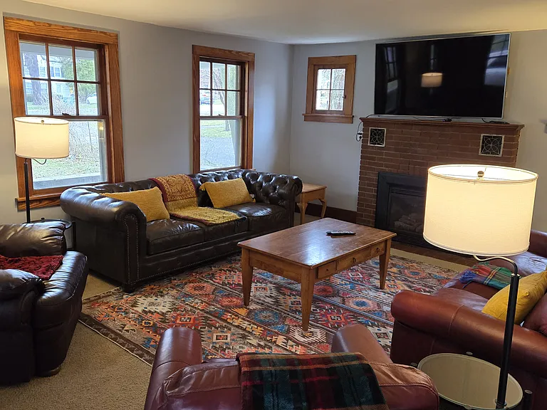 Living Room with gas fireplace, all downstairs windows have blinds.