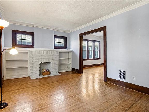 Beautiful living room with decorative original fireplace