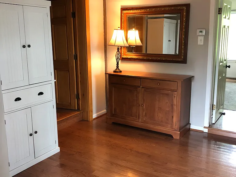Hallway area between bedrooms and kitchen. Hardwood floors throughout.