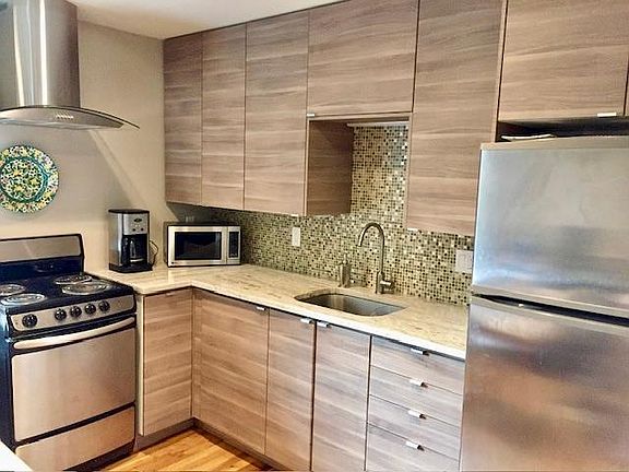 Stainless steel appliance, granite countertop and hardwood floors make for an updated kitchen.