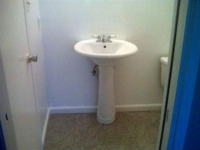 Pedestal sink in bathroom.