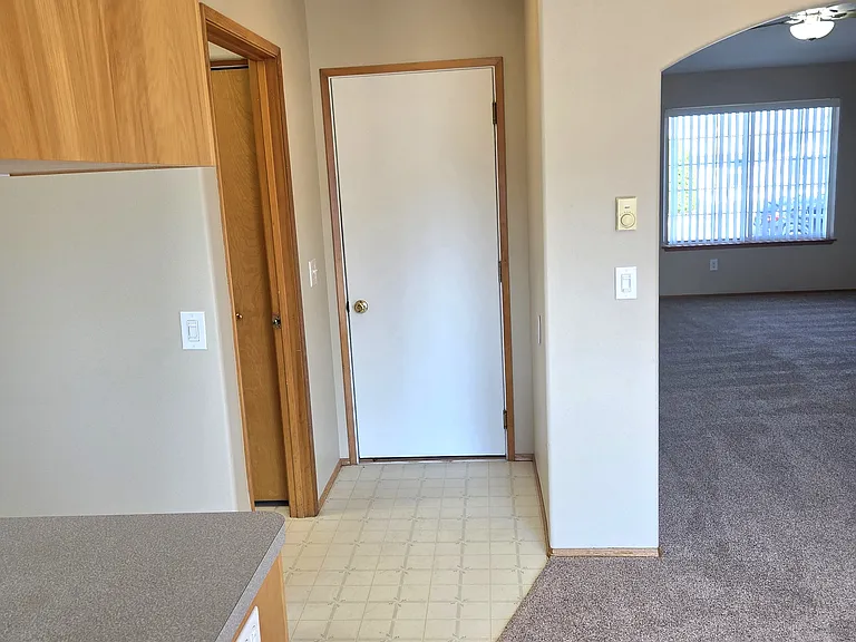 View to the garage entry door and the laundry room.