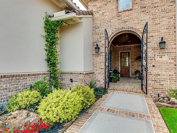 Front entrance to the home is just beyond the wrought iron gates through the covered courtyard.