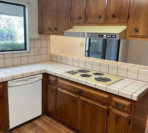 Kitchen with electric range, dishwasher, disposal