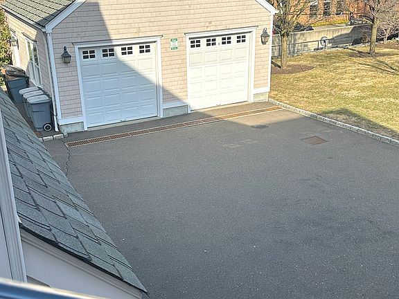 Two Entrances to Apartment - Back Views to 1 Car Garage (on Left Side) + 
 Additional Driveway Parking for 1 Car