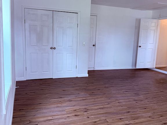 Expansive master suite or living area located right off the kitchen , featuring a private entrance, large covered porch, and oversized walk-in closet. Perfect for guests, in-laws, or a private retreat.