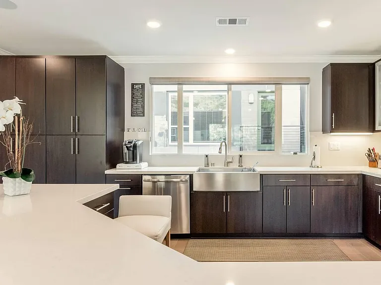 Sumptuous kitchen countertop spaces embrace the huge natural stone center island.