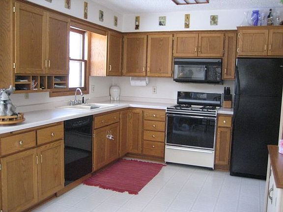 Cupboards abound in this updated kitchen featuring a newer DW & Fridge