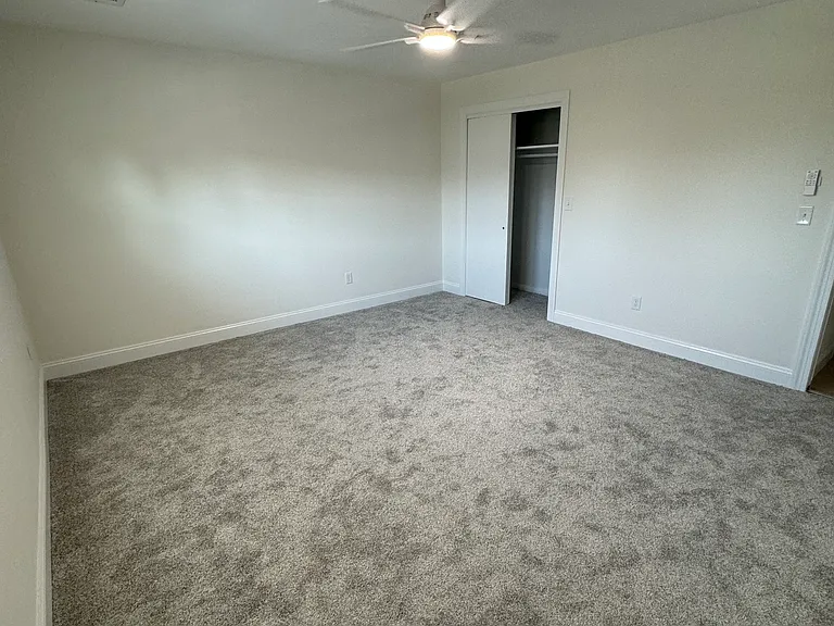 Bedroom # 1 17X16 with a spacious closet and a ceiling fan.