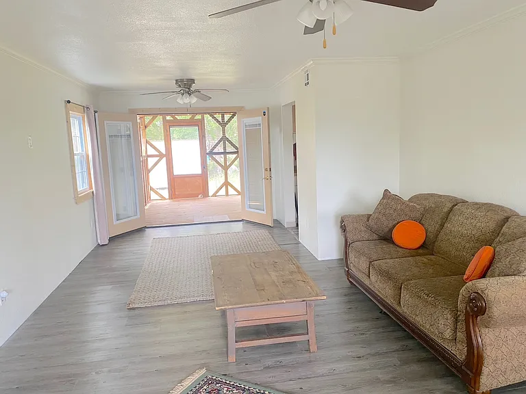 Living room opens up to screened in deck with additional living space