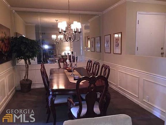 Spacious dining room has a mirrored wall & picture molding.