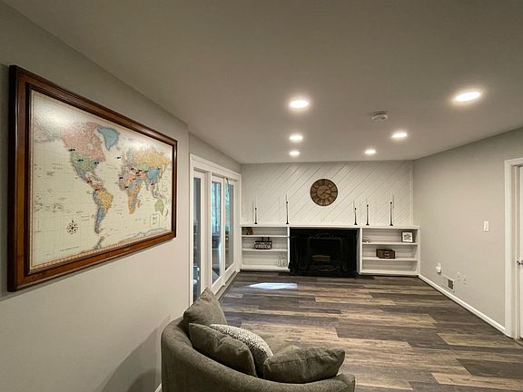 Family room with a wood burning fireplace and built in book cases which connects to the sunroom