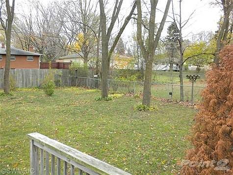 Back yard has deck leading to the living room.