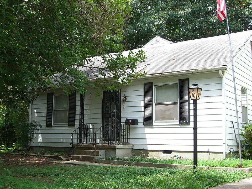 Cute exterior with shade trees.