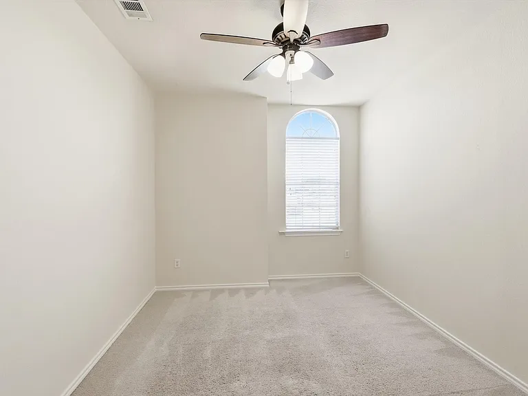 Bedroom 4 up facing the front. Fan, light colors and lots of light.
