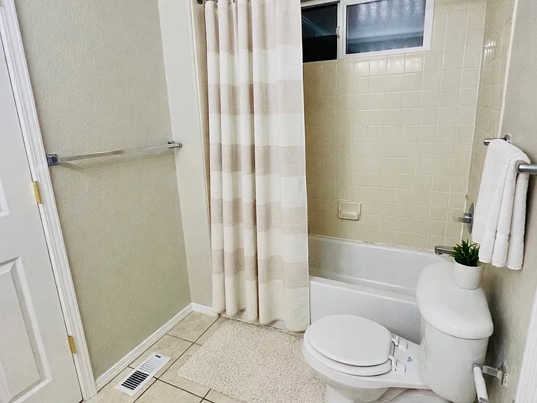 Upstairs full bathroom tub/shower, virtually staged with decor only