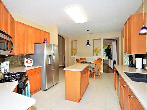 Large Kitchen with Silestone Counters, tile back splash, and Stainless Steel Appliances.