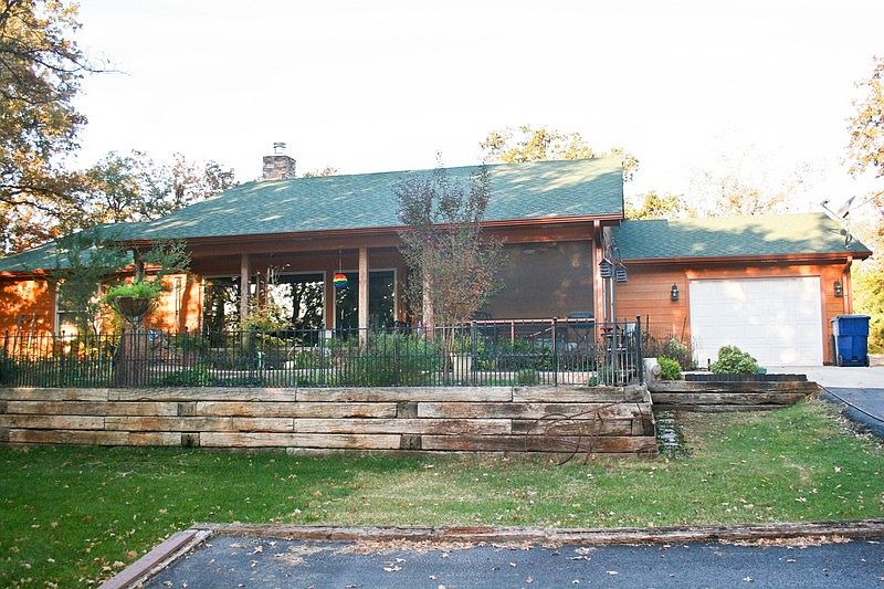 Front of House : Shows 2 extra paved parking spaces in drive.