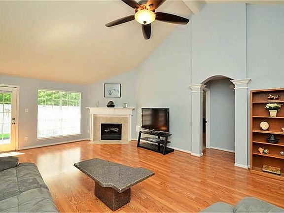 Spacious living area with laminate wood floors