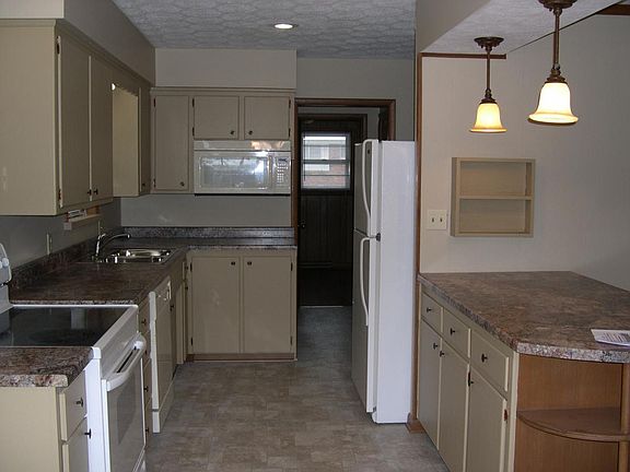 Kitchen...west side wall, with extra cabinets and counter/ba
