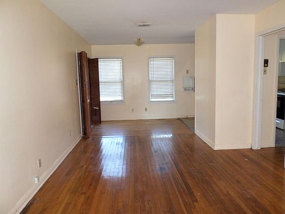 dining room with bonus room to the left and kitchen to the right